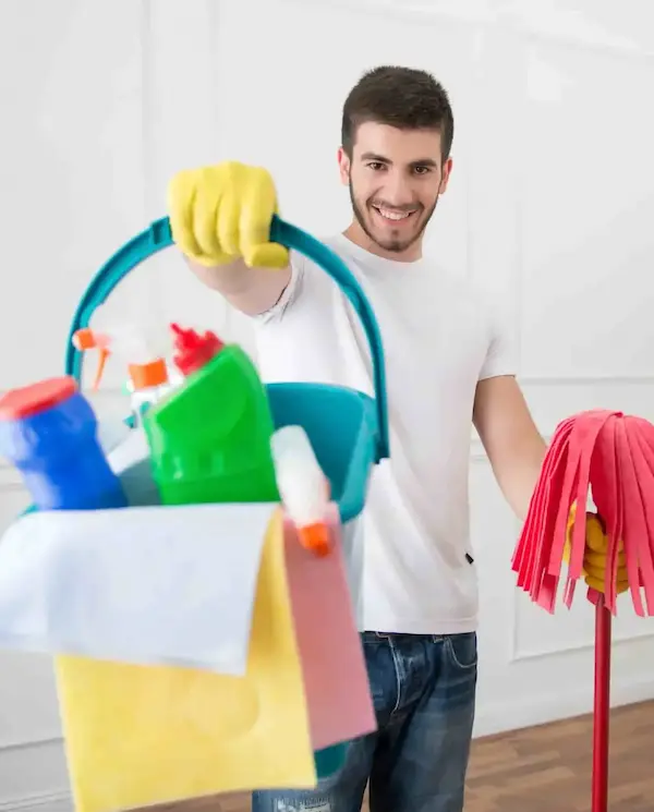 Person cleaning the house, using a broom and cleaning products - find the job on askaide.com.