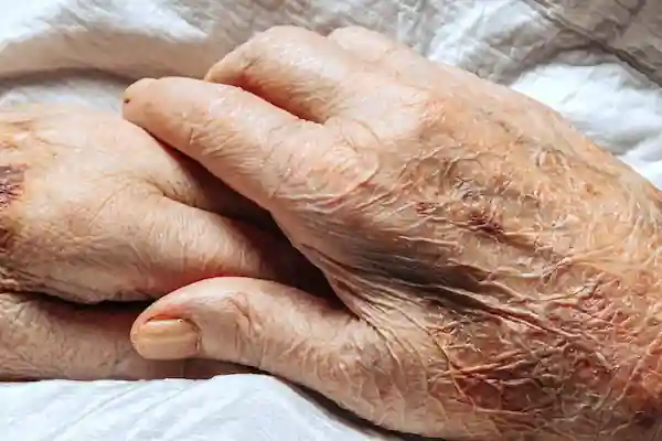 Deux mains de personnes âgées, avec des rides et des veines visibles, symbolisant des seniors ayant besoin d'aide.